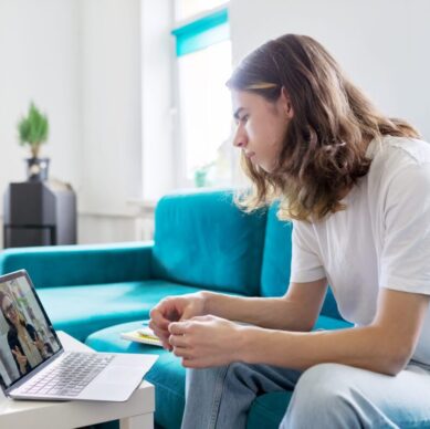Individual online lesson, teenage boy sitting at home with laptop, studying using remote video consultation, female teacher mentor on computer screen. E-education, technology in teaching, adolescence
