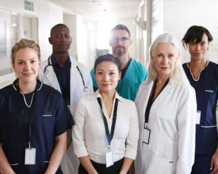 Portrait Of Medical Team Standing In Hospital Corridor