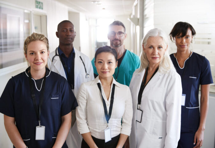 Portrait Of Medical Team Standing In Hospital Corridor